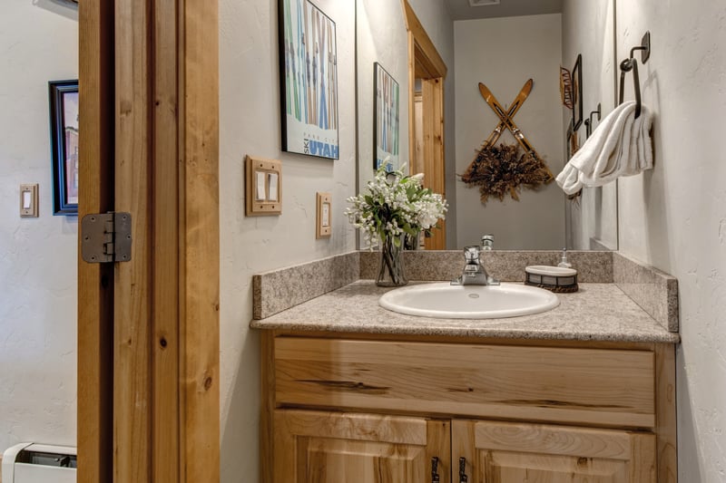 Charming ski-themed bathroom with rustic wood and cozy mountain decor.