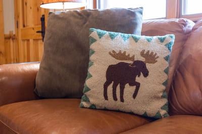 Rustic comfort meets lodge charm with this moose-themed pillow.