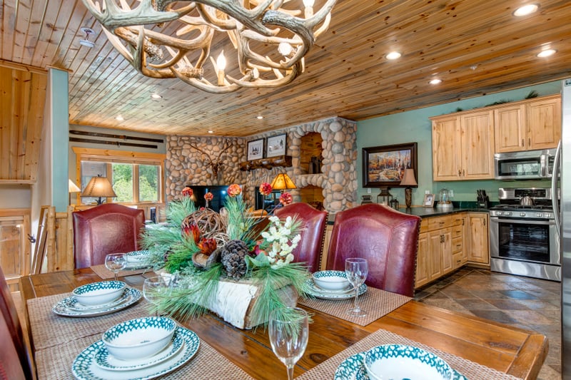 Wood ceilings and warm lighting make every meal around this large dining table feel special.