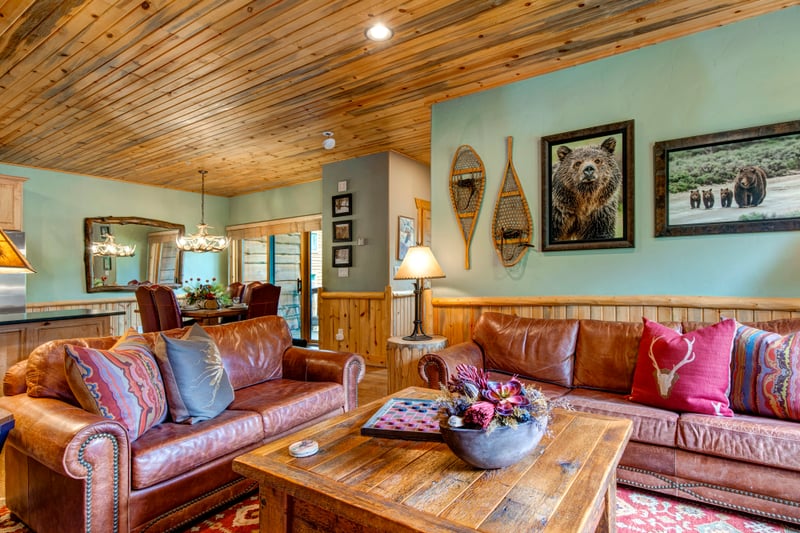 Open-concept living area with a large sectional sofa and a fireplace invites cozy evenings with the whole group.