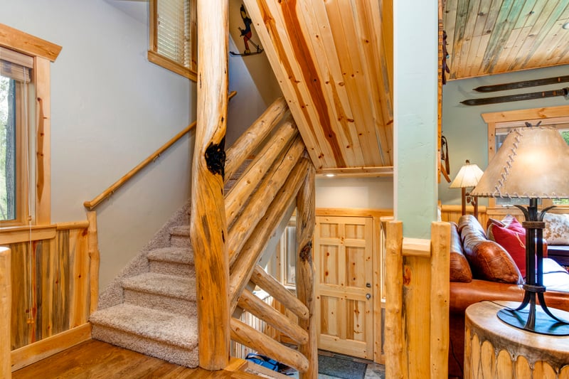 Stairs lead to both bedrooms upstairs, creating privacy while keeping the living and dining areas connected.