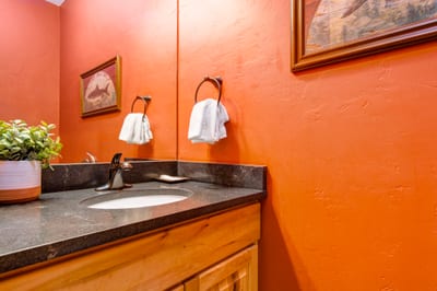Convenient powder bath on the main level includes modern finishes and easy access from living areas.