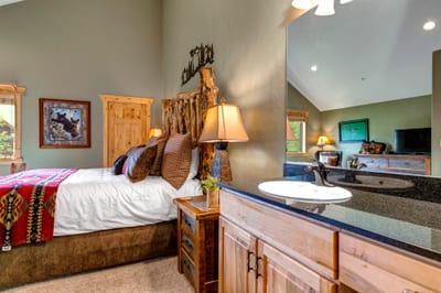 Upstairs ensuite includes granite finishes and rustic wood details for a classic lodge feel.