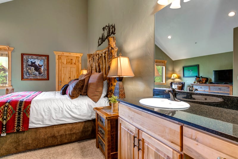 Upstairs ensuite includes granite finishes and rustic wood details for a classic lodge feel.