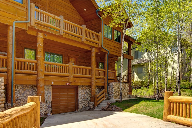 Cozy log cabin nestled among trees with private garage access. TWL-5B