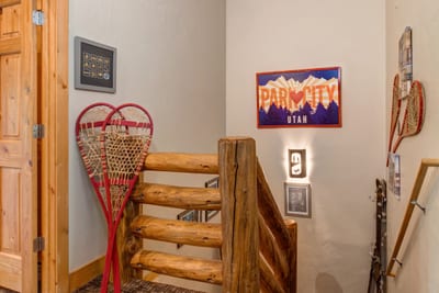 Rustic stairwell with vintage snowshoes and Park City decor.