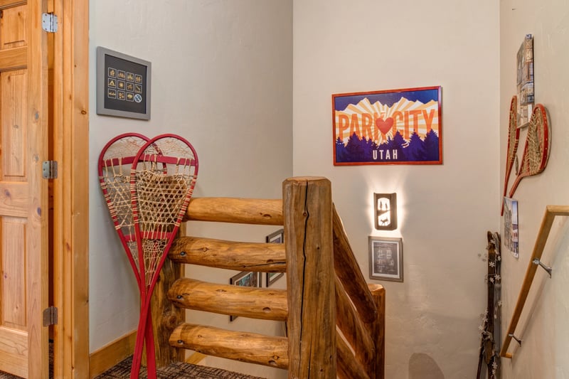 Rustic stairwell with vintage snowshoes and Park City decor. TWL-5B