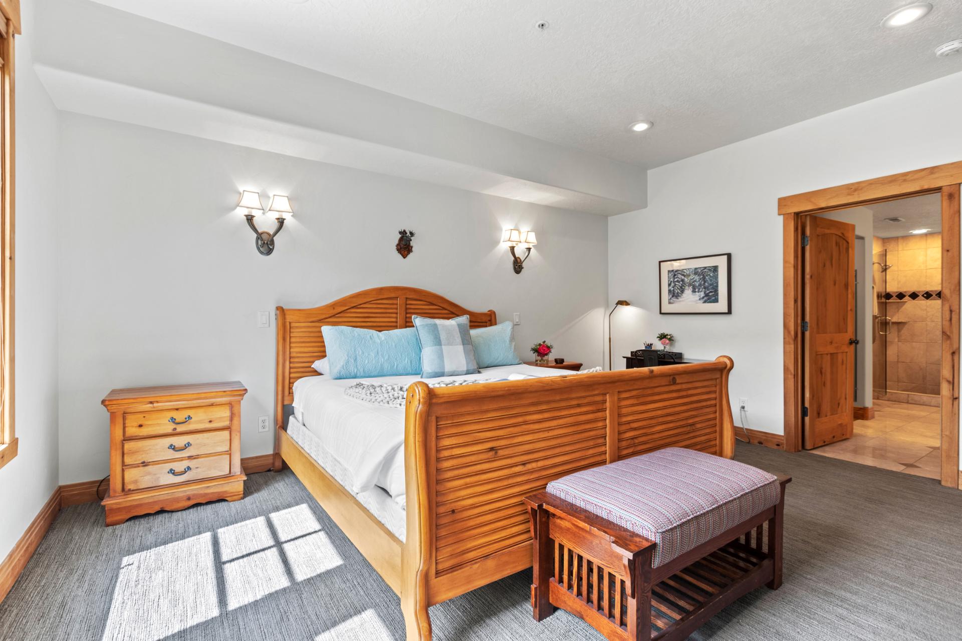Your spacious primary suite features a King bed, wood furnishings, and private ensuite bath.