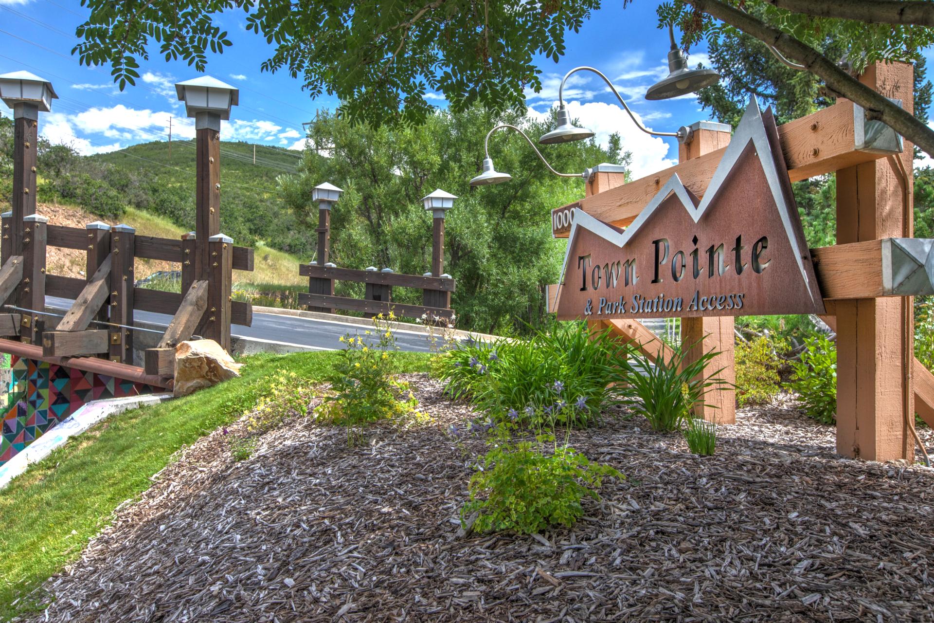 Pine trees and manicured grounds create a peaceful mountain arrival.