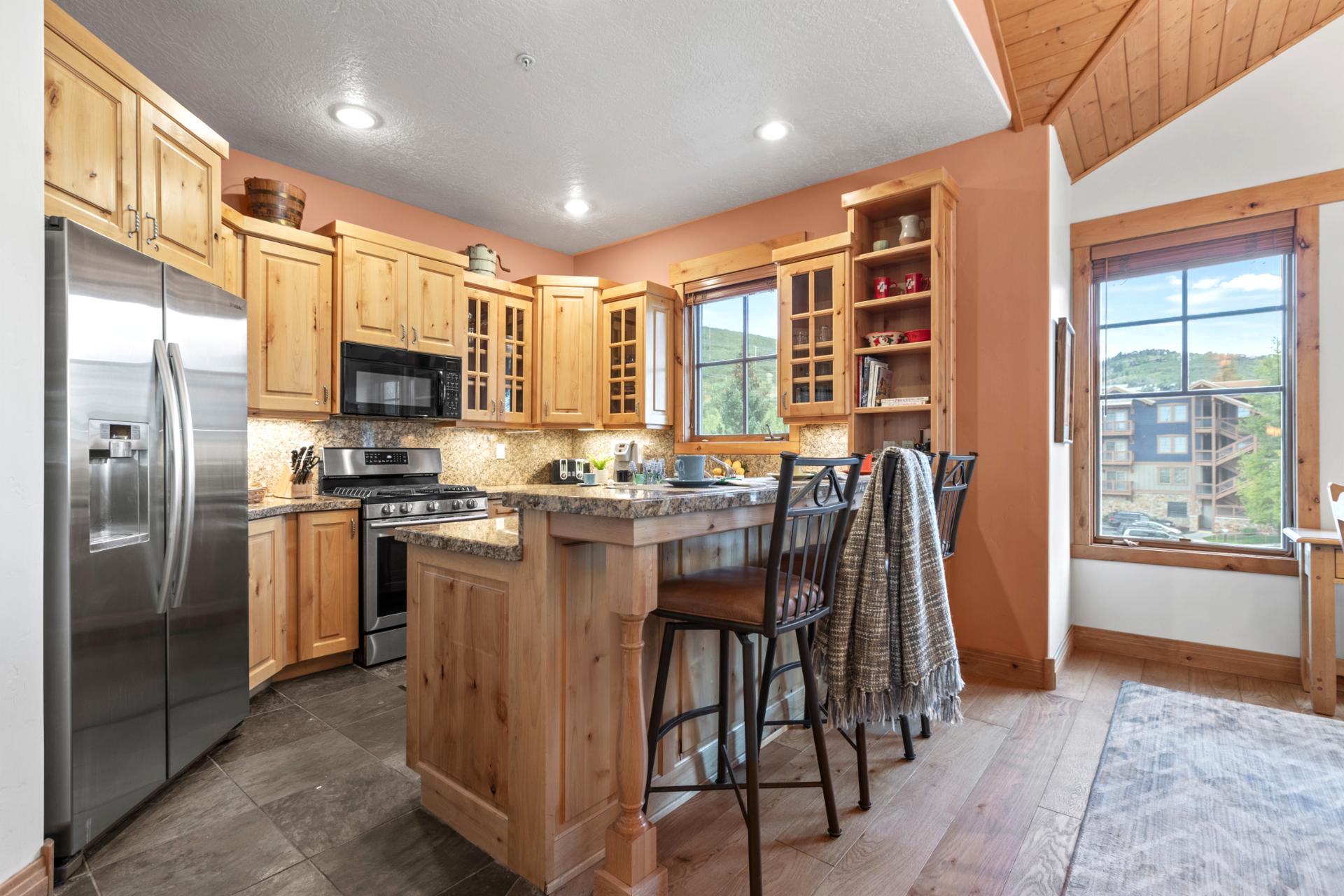 Alternate kitchen view highlights the island bar and open layout into the dining area.