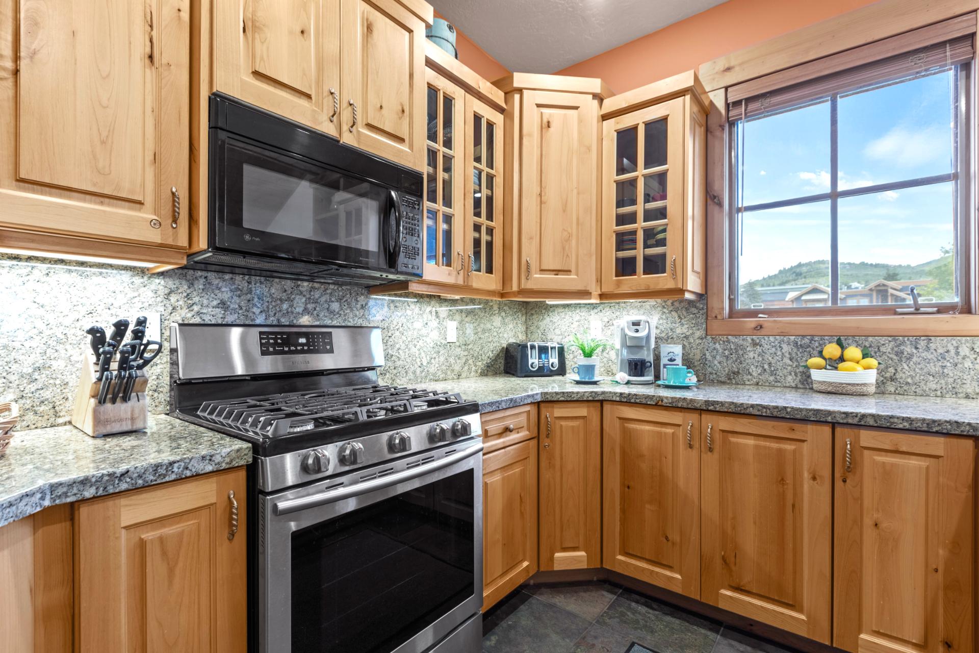 Fully equipped kitchen with stainless appliances, granite counters, and plenty of prep space.
