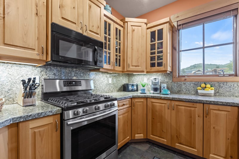 Fully equipped kitchen with stainless appliances, granite counters, and plenty of prep space.