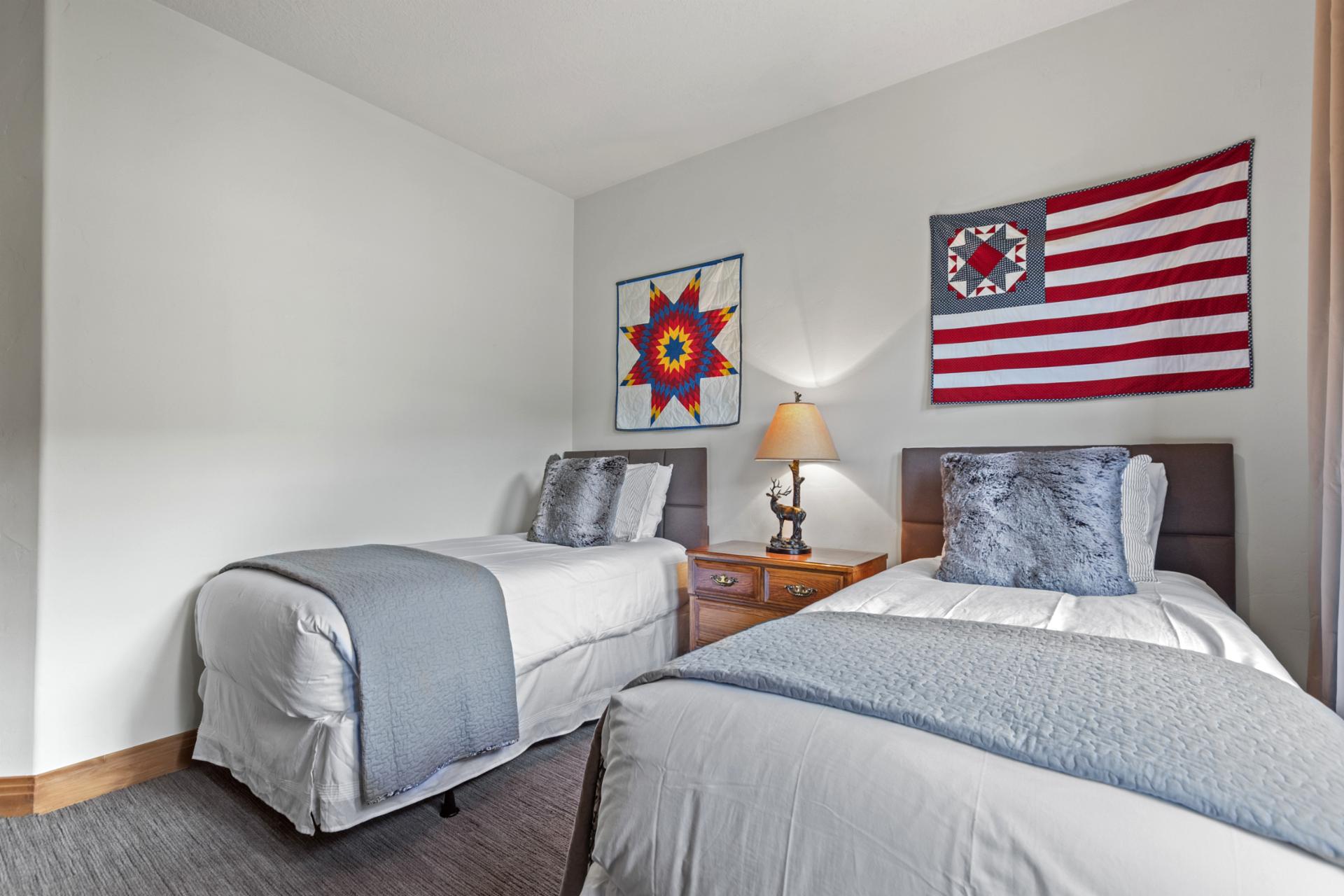 Twin layout with forest views and a bright, airy feel.