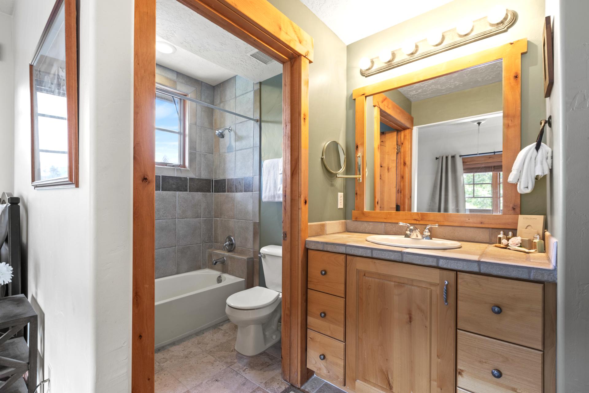 Attached to Bedroom 2, this full bath features stone counters and a tub/shower combo.