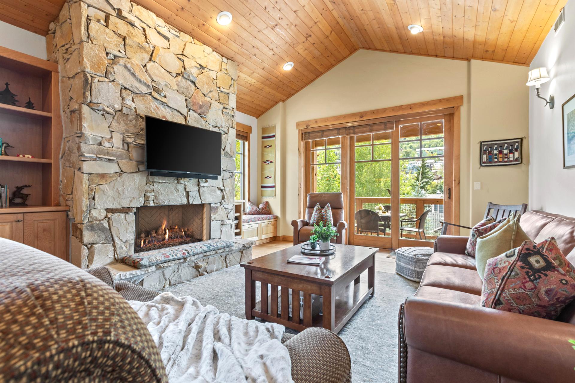 Relax in your mountain-inspired living room with stone fireplace, Smart TV, and access to the balcony.