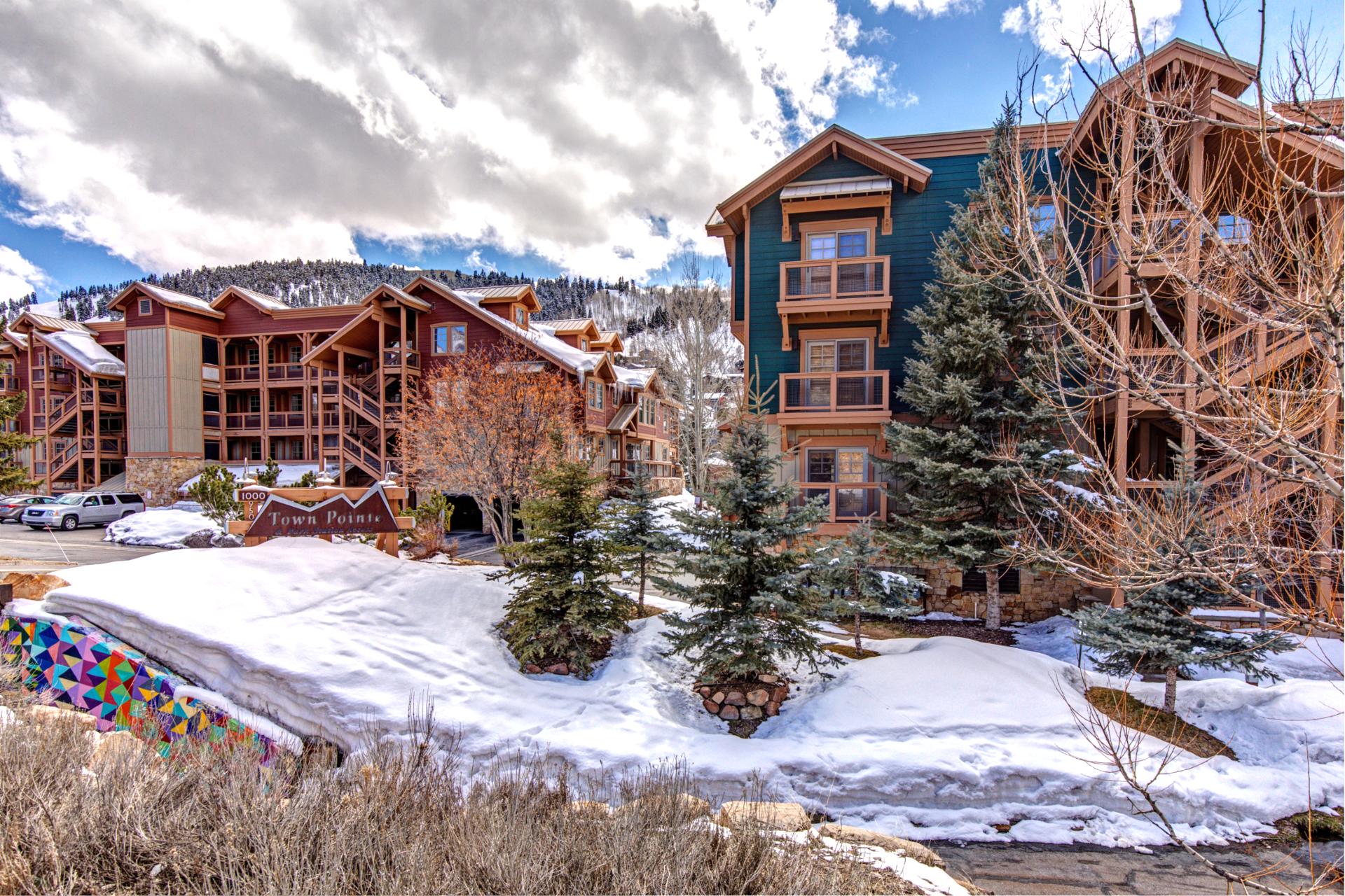 The lodge exterior blends alpine charm and easy access to resort amenities and trails.