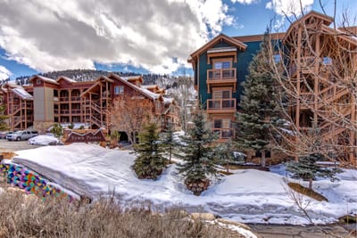 The lodge exterior blends alpine charm and easy access to resort amenities and trails.