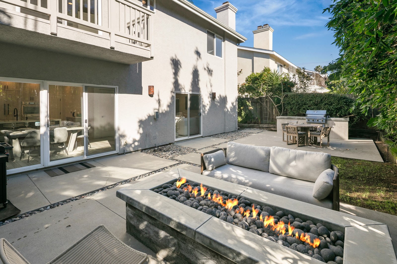 Outdoor seating creates a comfortable spot to gather, grill, or enjoy mild coastal evenings together.