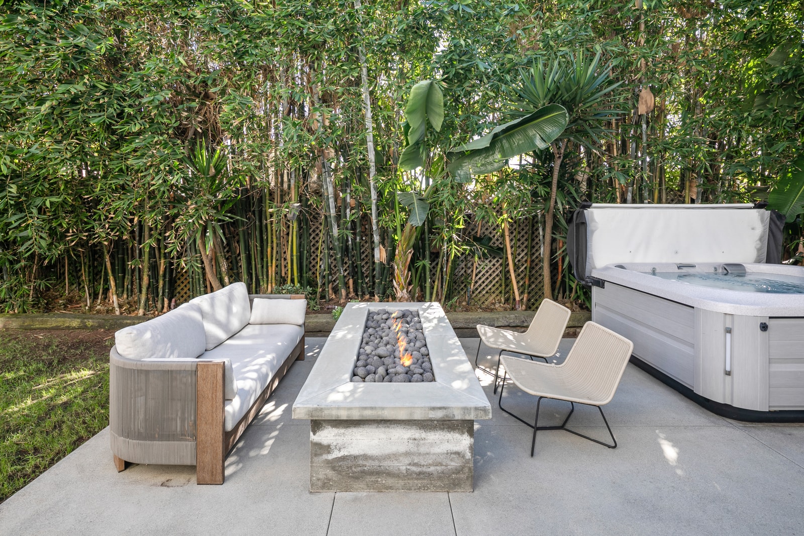 Another view of the hot tub shows its secluded setting, designed for evening soaks and easy relaxation.