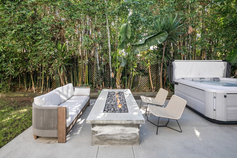 Another view of the hot tub shows its secluded setting, designed for evening soaks and easy relaxation.