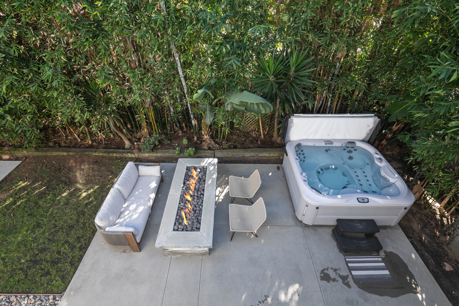 Slip into your private hot tub surrounded by greenery, a relaxing way to end days spent exploring the coast.