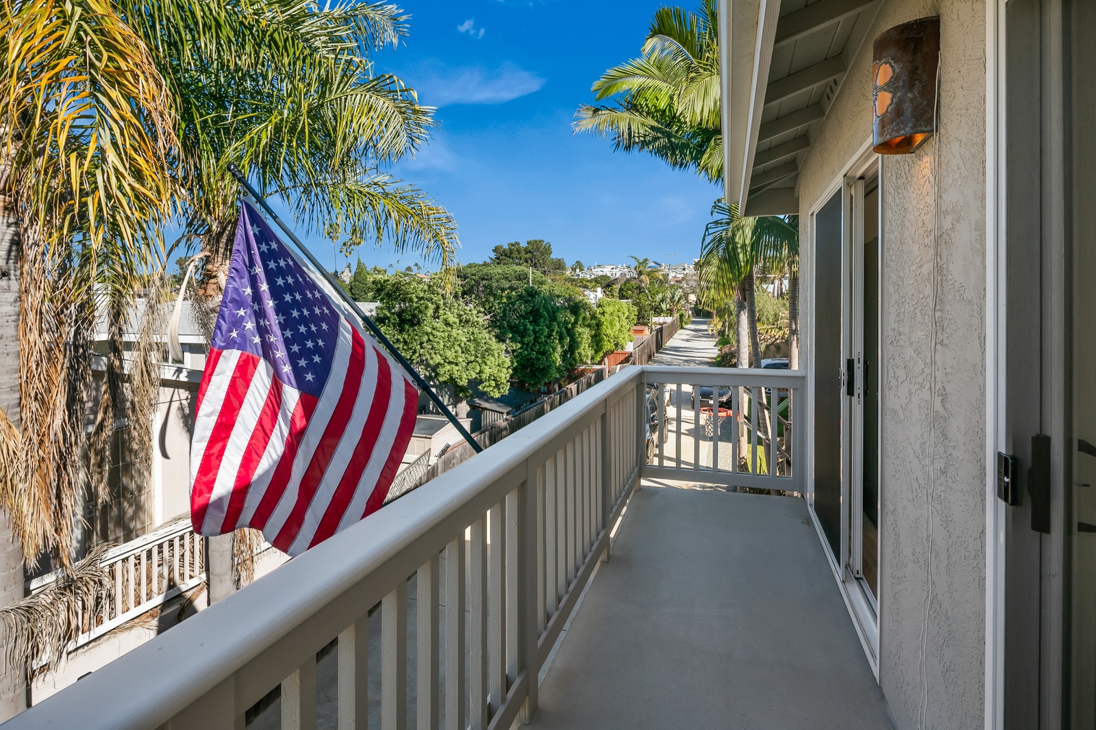 Start your morning on the balcony with coffee in hand, enjoying a quiet perch above the yard and surrounding palms.