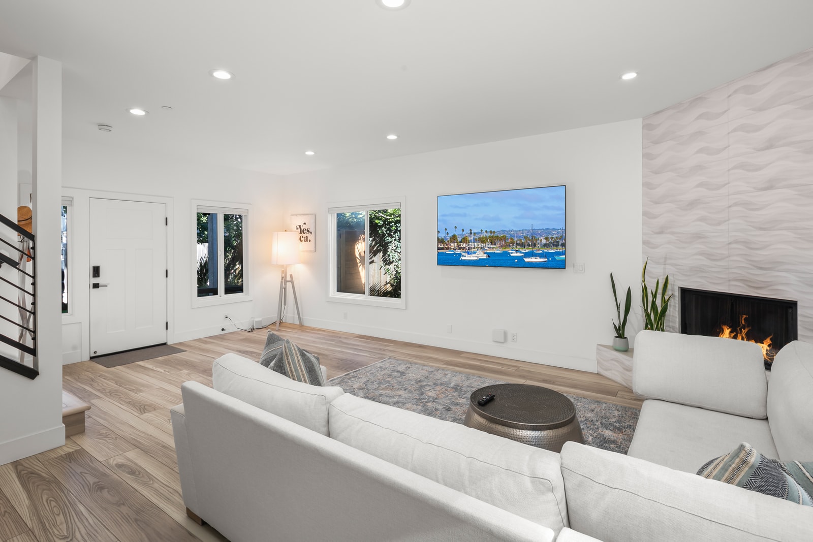 Gather in the central living area where generous seating and wide sightlines make the home feel open and easy to share.