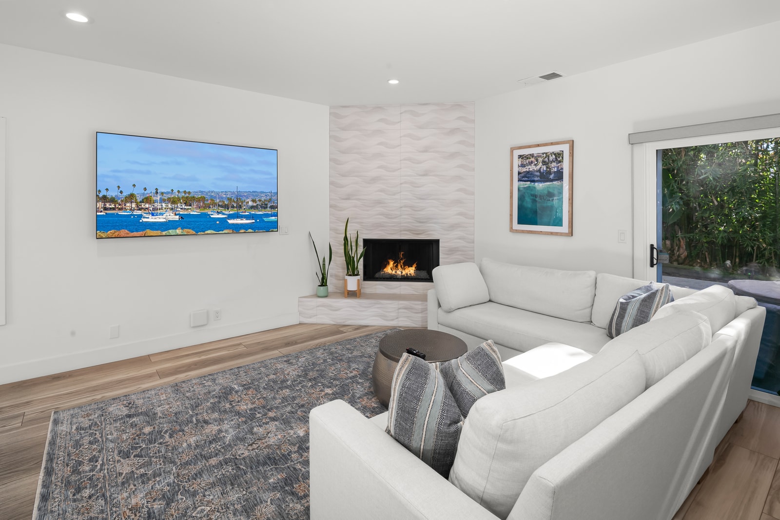 Settle into your bright living room with plush seating and a large wall mounted TV, ready for relaxed movie nights after the beach.