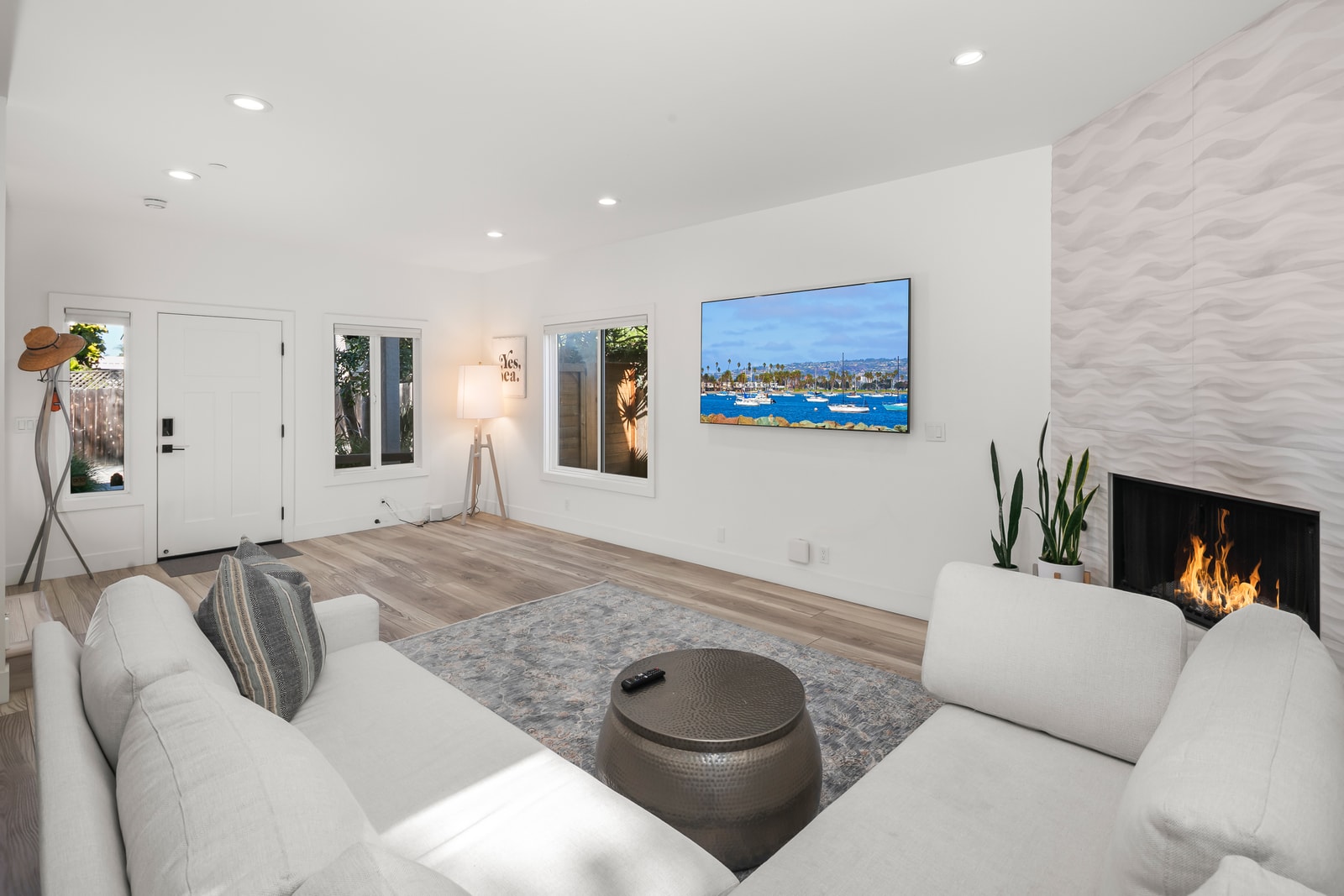 Coastal artwork and comfortable seating frame your main lounge, giving you a welcoming place to stream favorites and unwind together.