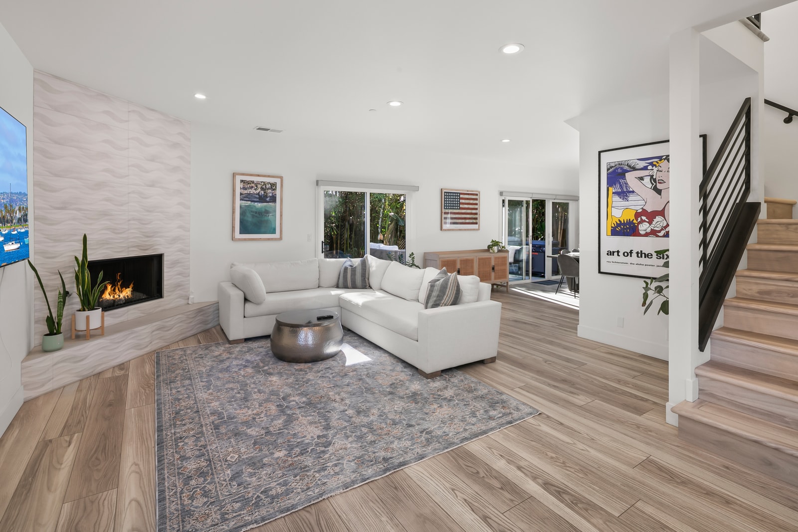 Settle into the bright living room with plush seating and a large wall mounted TV for easy movie nights together.