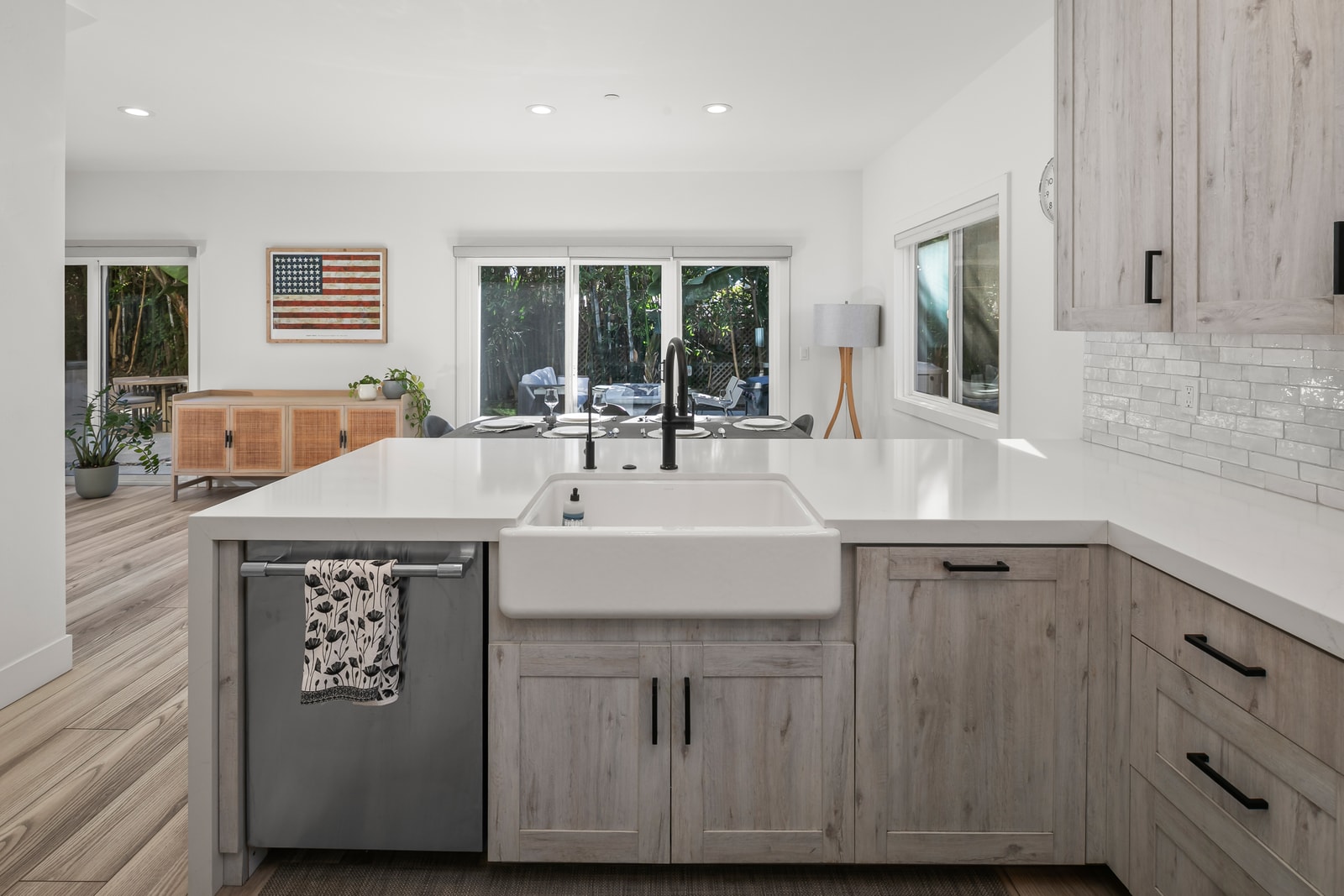 Cook with ease at the oversized island featuring bar seating, generous prep space, and clear views toward the yard.