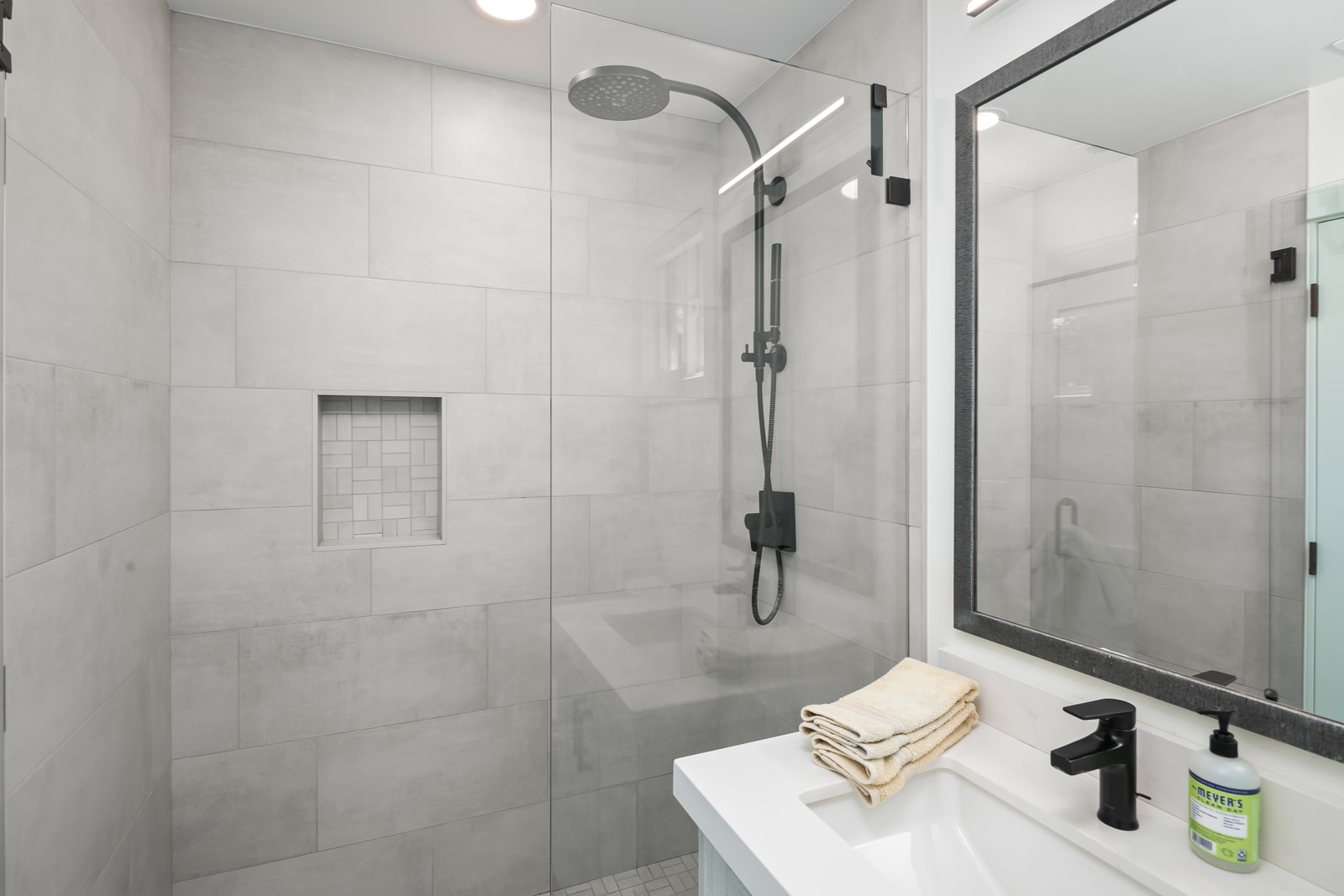 Guest bathroom includes a clean, updated vanity and shower, giving visitors a comfortable space to refresh.