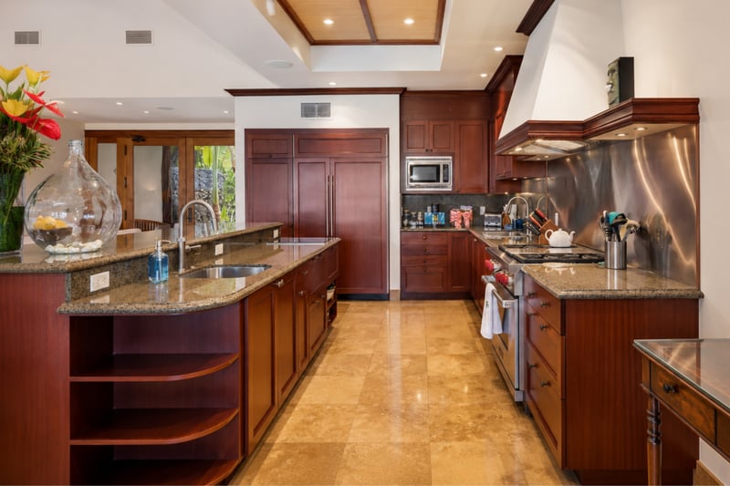 Dark wood cabinetry and stainless appliances give the kitchen a refined, polished feel