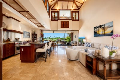 The main living area features high ceilings, wood details, and an open, airy layout