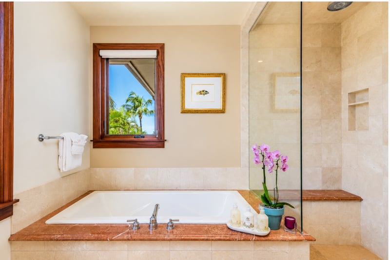 The primary bath offers a deep soaking tub and a spacious walk-in shower