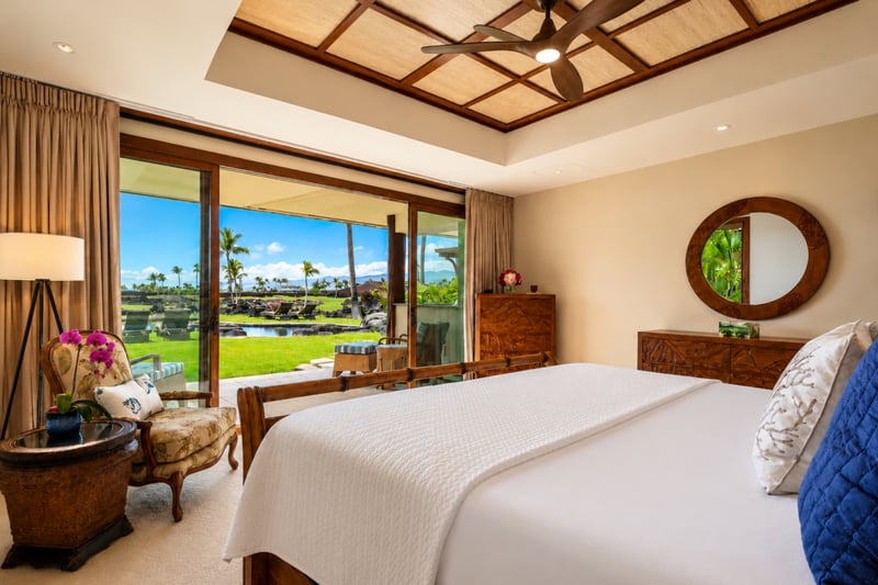 The ground-floor bedroom features a king bed and direct access to the lanai and pool