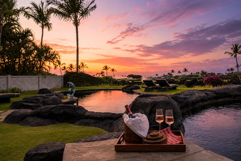 Relax by the pool with a drink and a gorgeous sunset view