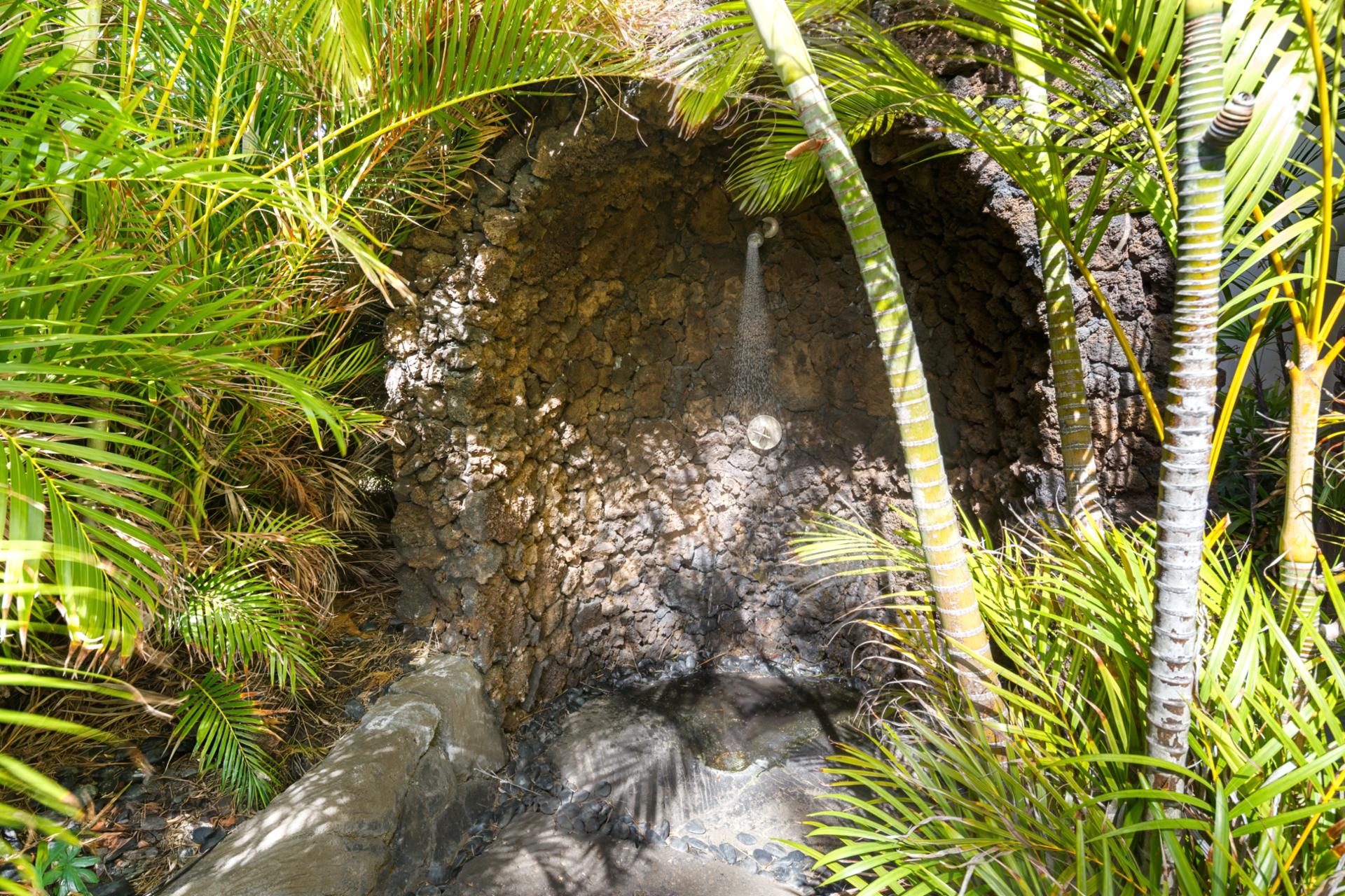 Rinse off under your own private lava rock outdoor shower, surrounded by lush tropical foliage. An island experience that blends nature with luxury.