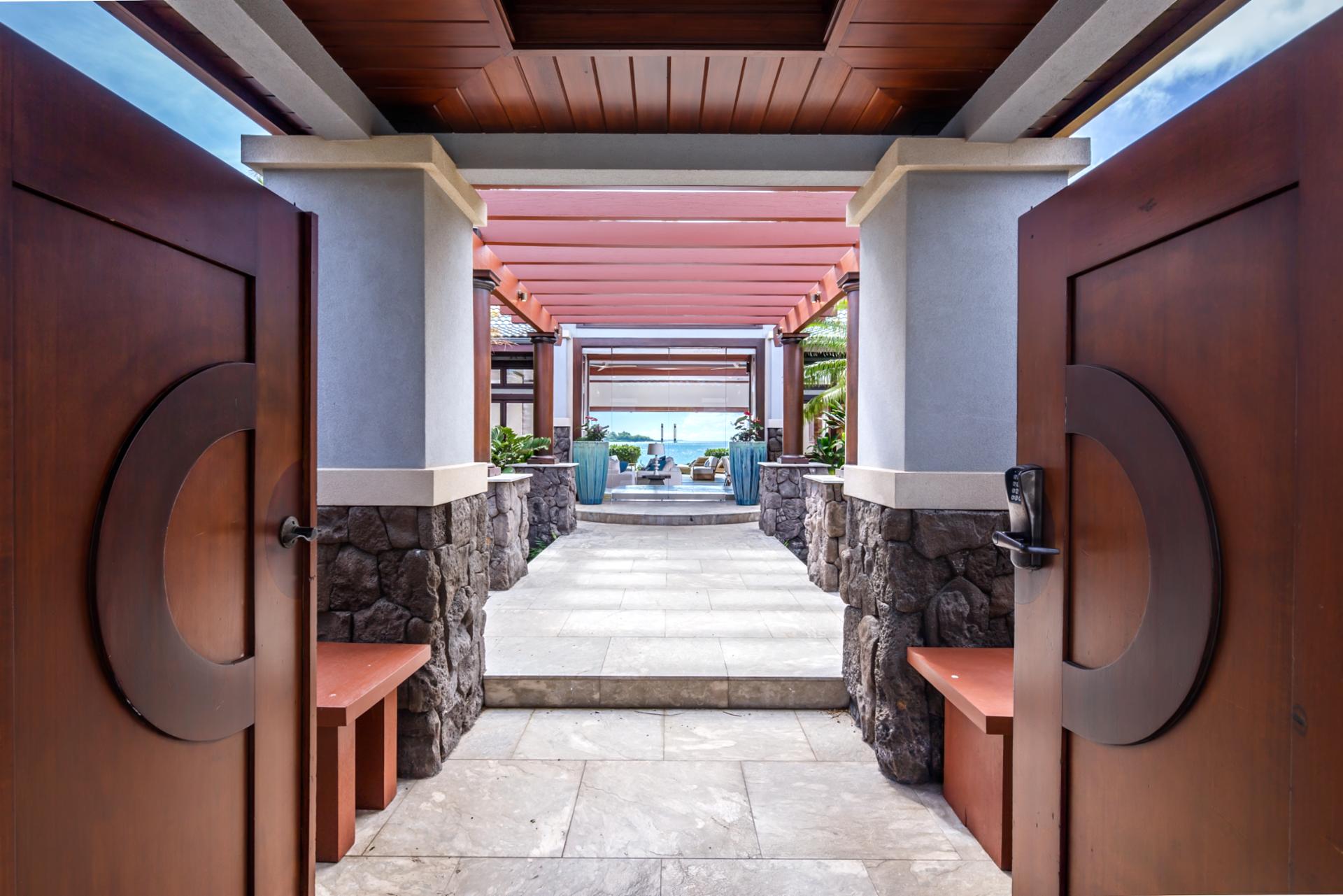 The central walkway connects the entry to the lanai, living, and dining areas for indoor-outdoor flow.