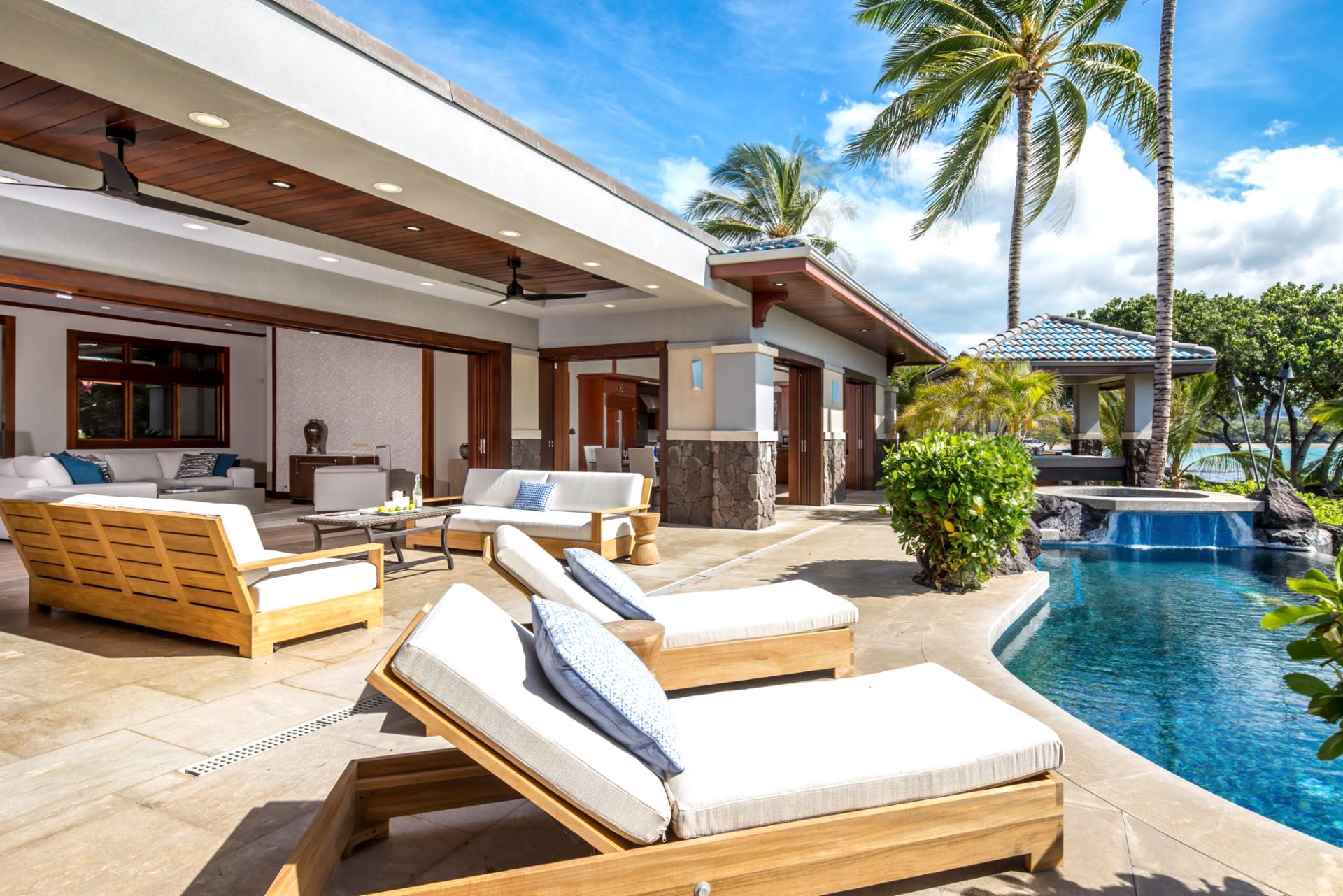 Palm trees frame your pool and patio, creating a peaceful retreat just steps from the house.