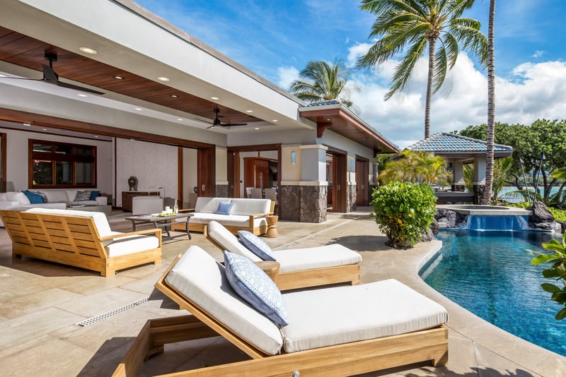Palm trees frame your pool and patio, creating a peaceful retreat just steps from the house.