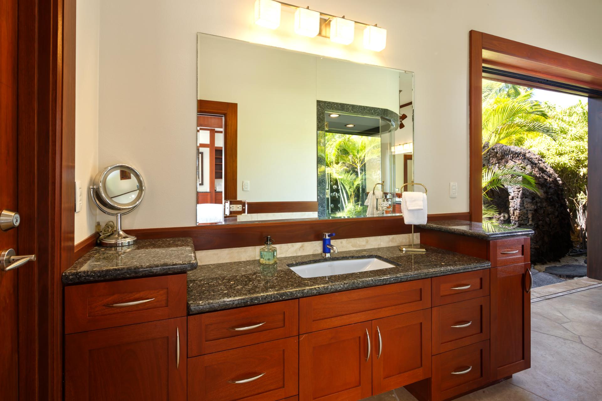 Your ensuite bath features dual vanities, warm wood cabinetry, and plenty of natural light.