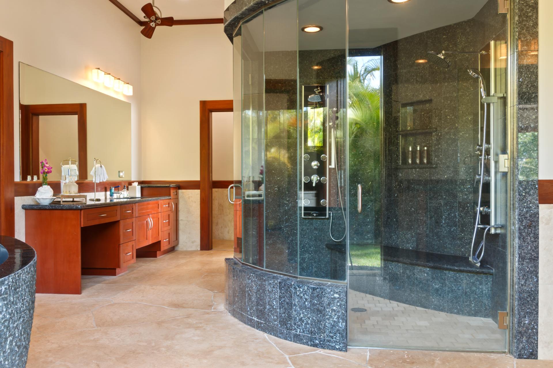 Indulge in spa-like luxury in the master bath featuring a stunning glass-enclosed walk-in shower with multiple rain heads, body jets, and a sleek granite finish. Your private oasis of relaxation.