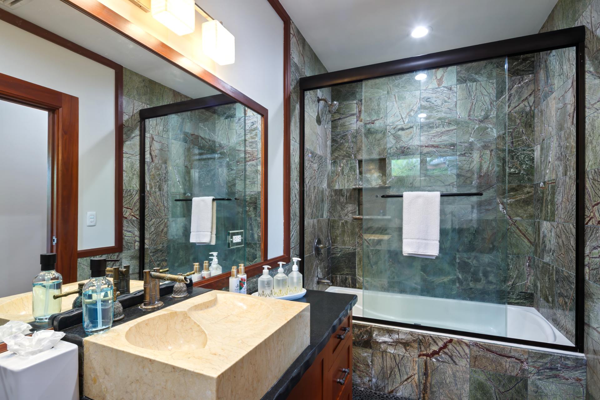 Clean design and natural light elevate this walk-in shower guest bath.