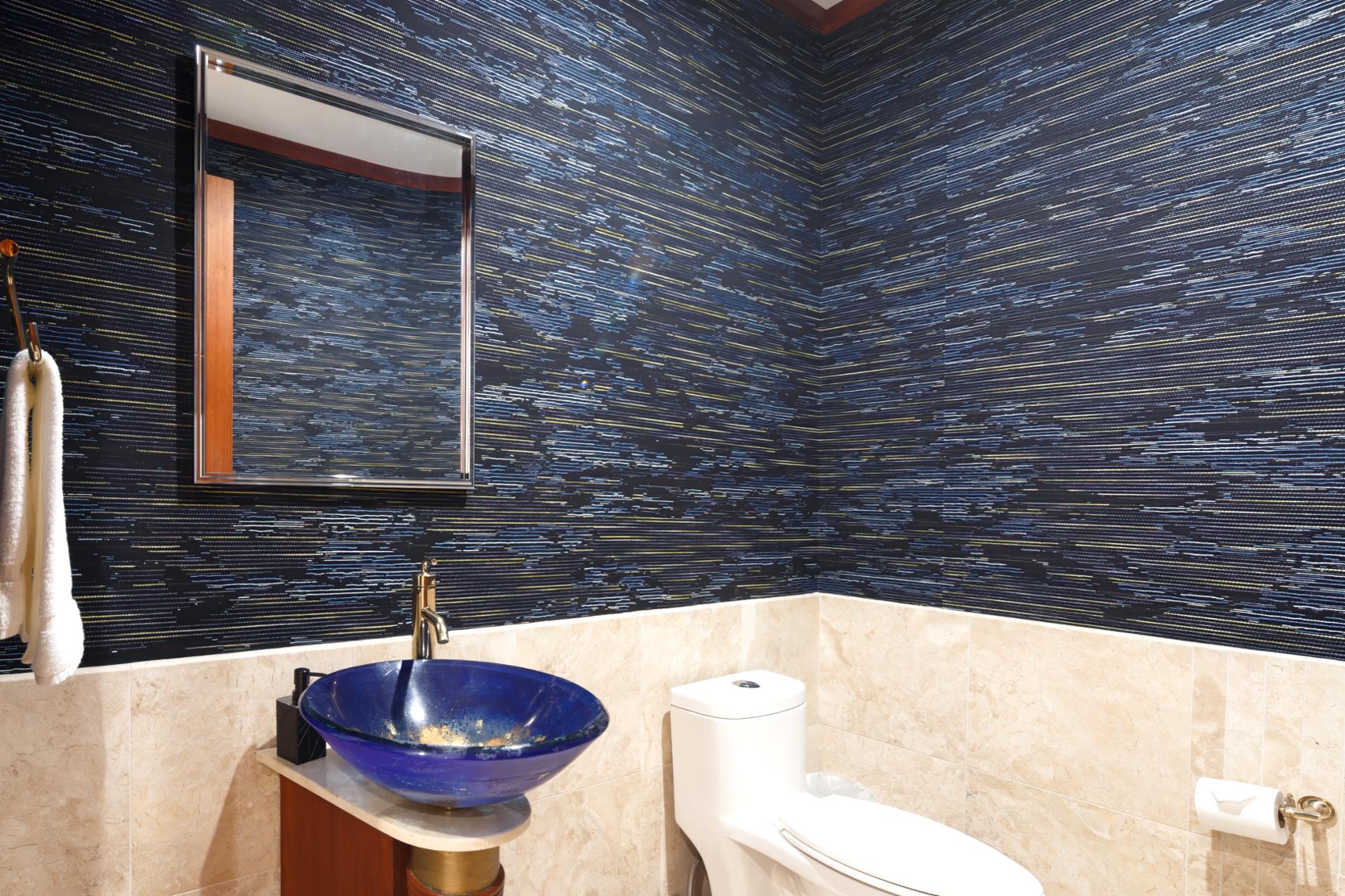 Custom tilework and vessel sink add a modern touch to this fourth guest bathroom.