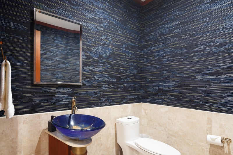 Custom tilework and vessel sink add a modern touch to this fourth guest bathroom.