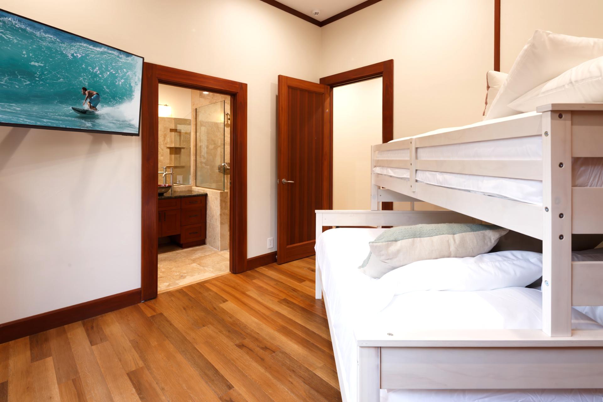 Fourth bedroom sleeps up to five with a Queen bed below and a Twin on top, great for families.