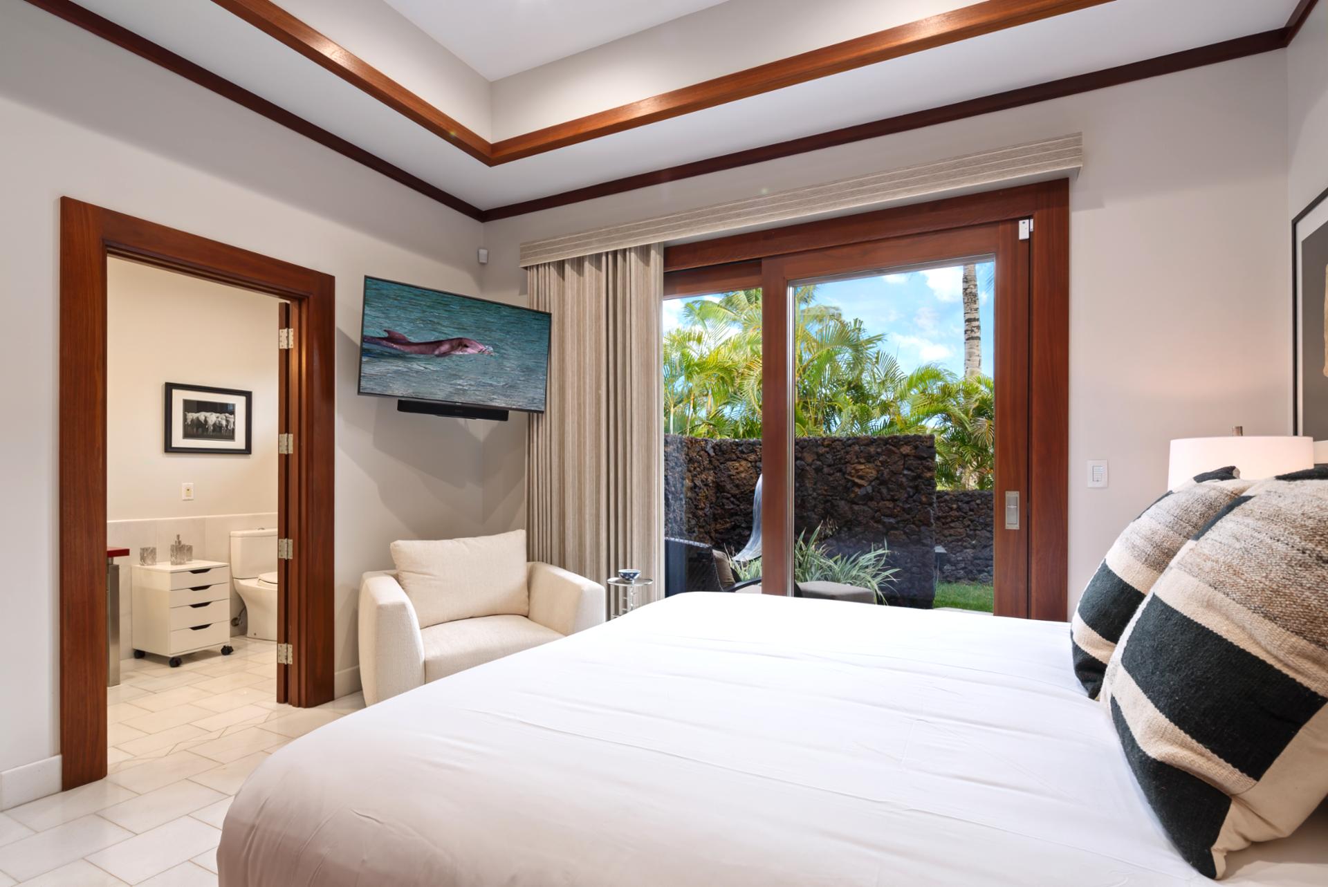 Third King suite includes direct access to the lanai and warm wood finishes.