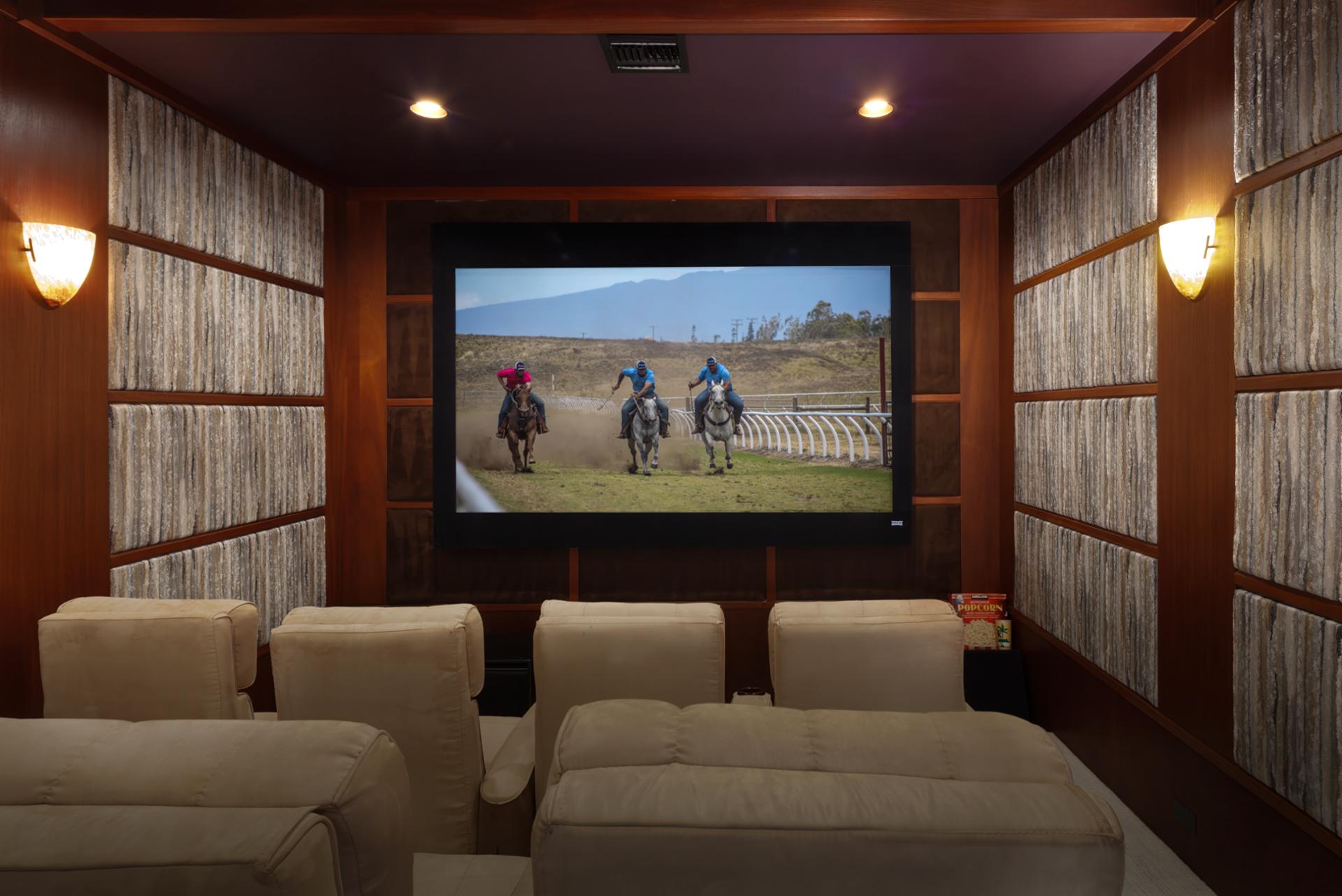 Theater room with a projector and lounge seating is perfect for movie nights in.