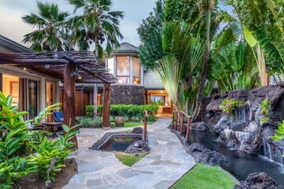 The lush tropical pathway winds through the property